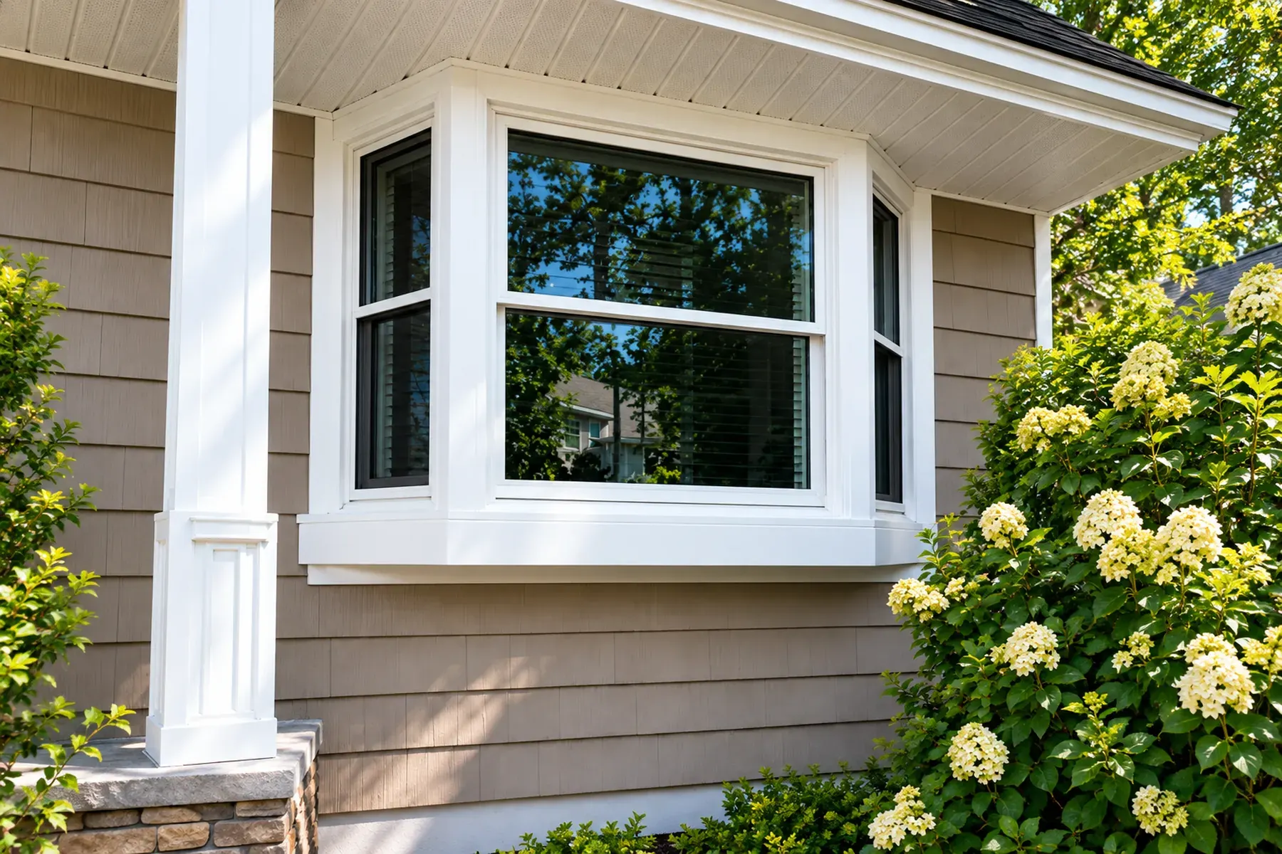Newly installed white bay window with finished exterior trim on a remodeled home in Encino, CA.