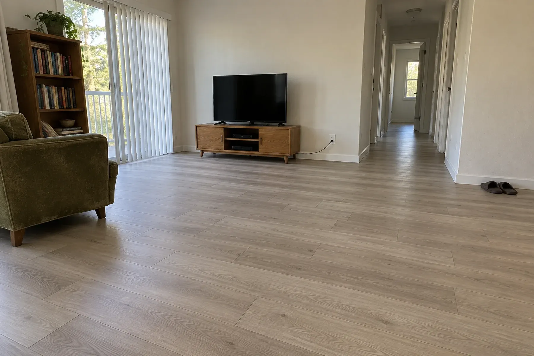 Continuous luxury vinyl plank floor running from a Culver City living room into the hallway