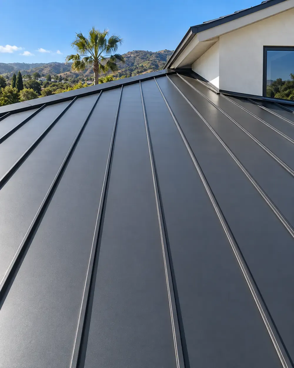 Metal roofing in Los Angeles, CA: dark standing seam metal roof on a modern home