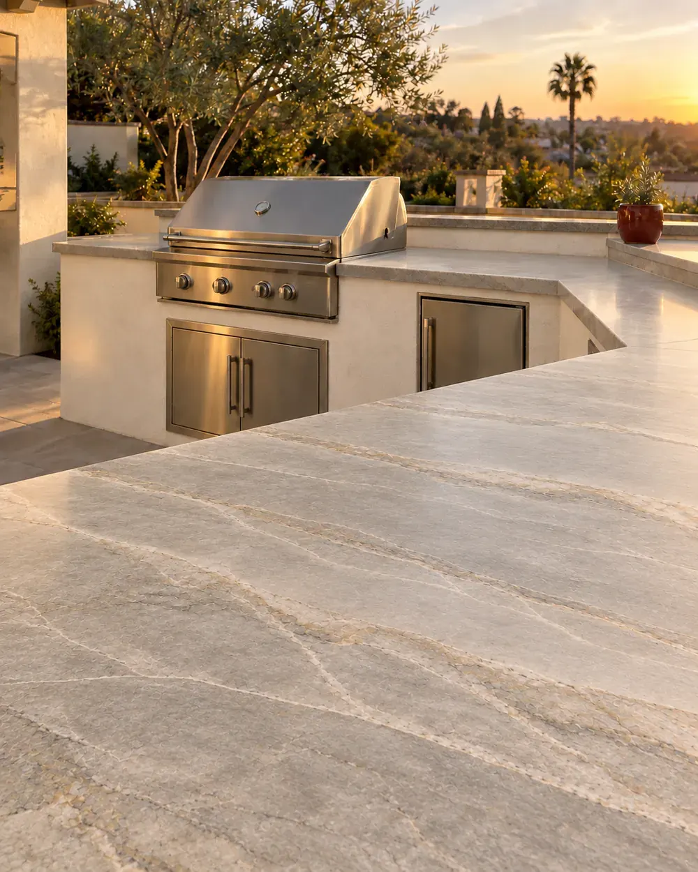 Outdoor kitchen countertop installation in Los Angeles, CA: stone bar top and grill island