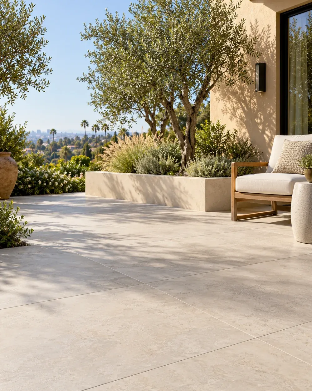 Outdoor tile installation in Los Angeles, CA: large-format patio tile with planters and a garden