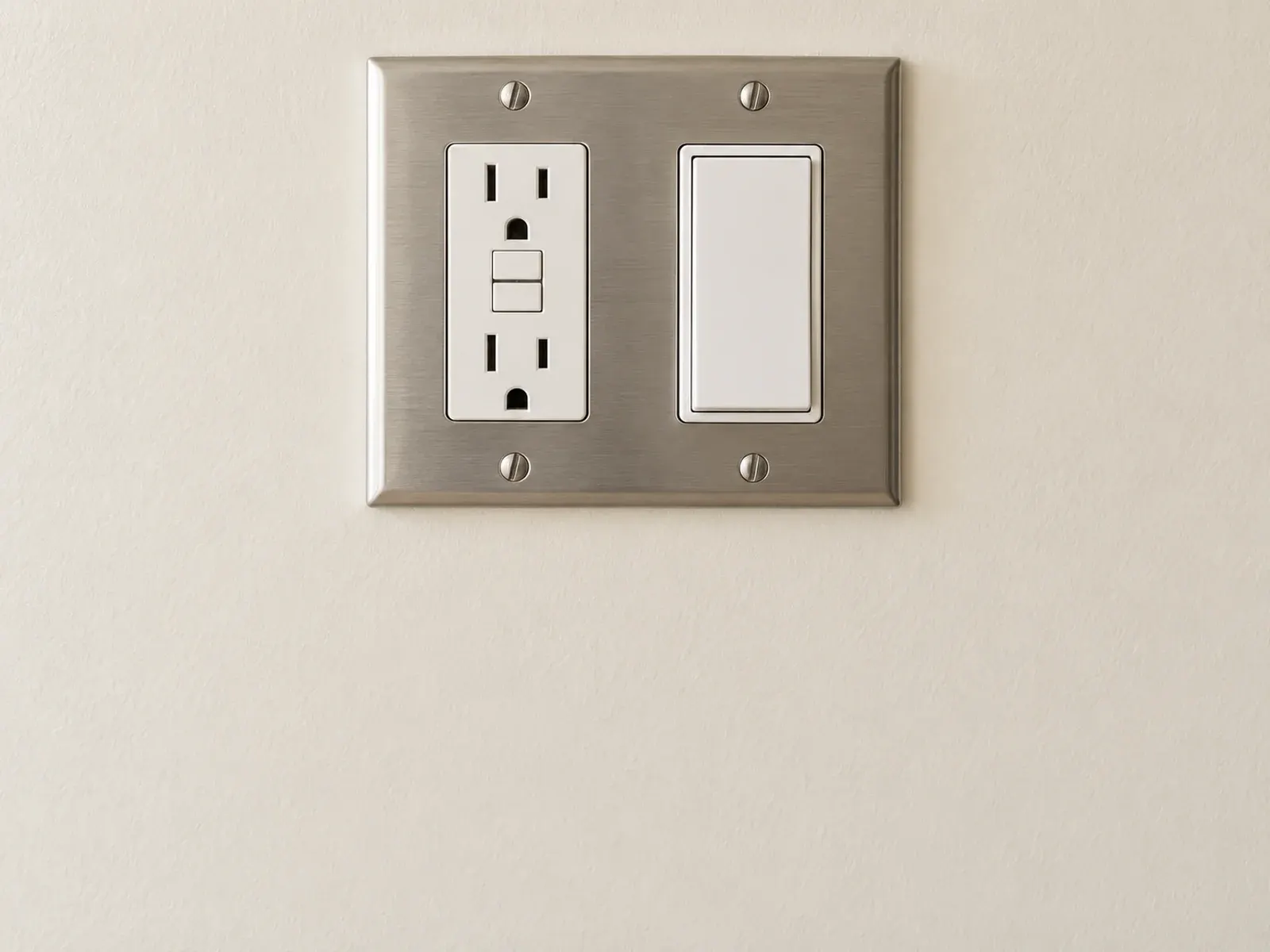 Outlet and switch installation in Los Angeles: GFCI outlet and rocker switch on a stainless plate